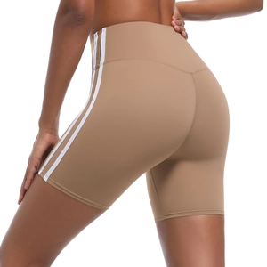 Detail view of high-waisted camel yoga shorts featuring three white side stripes