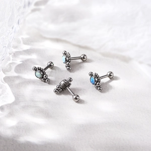Silver stainless steel screw-back cartilage earrings featuring vibrant blue opal stones