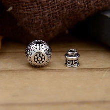 Macro shot of S925 sterling silver retro spacer beads with vintage hollow floral engraving