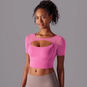 Close-up of pink fitness top featuring mesh splicing and teardrop cutout detail