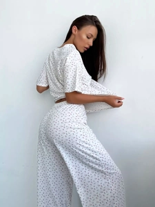 Detail view of heart floral print pajama set featuring relaxed short sleeve top and trousers