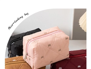 Detailed shot of bow-knot quilted cosmetic bags in pink, black, brown, and burgundy