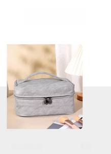 Detail view of large grey PU leather cosmetic bag with handle and dual zippers