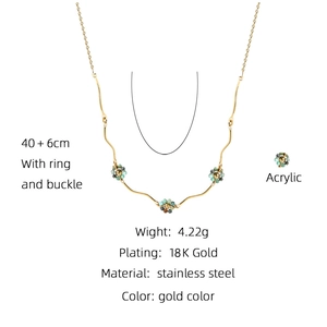 Detail view of 18K gold plated stainless steel necklace with acrylic floral charm