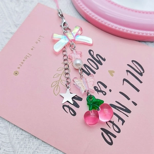 Sweet cherry and bow phone charm with pearls and silver stars on a pink card background