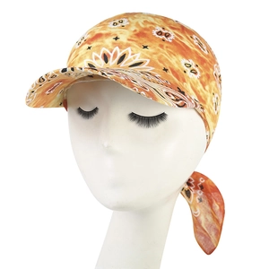 Detail of orange paisley bandana cap featuring breathable fabric and sun protection brim