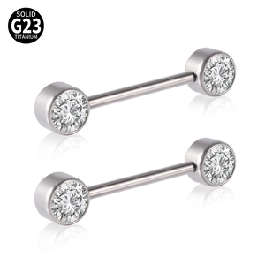 Macro shot of G23 titanium nipple rings with cubic zirconia and certification logo