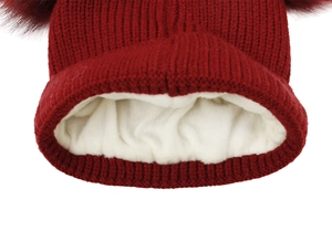 Detailed view of winter knit beanie showing wine red fabric and thick white fleece lining