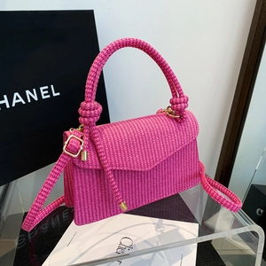 Pink woven crossbody bag with knot handle and gold buckle for elegant daily commute