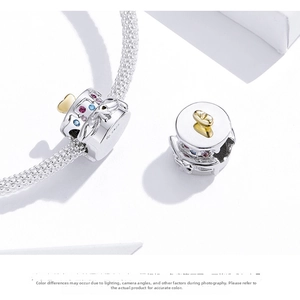 Macro detail of S925 sterling silver cake charm with colorful zircons and heart