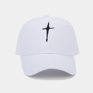 Close-up of black cross embroidery on a white cotton twill baseball cap with clean stitching