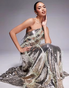 Detail of silver sequined one-shoulder evening gown featuring layered ruffle accents
