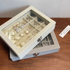 Detail view of velvet jewelry boxes with transparent glass lids and vintage metal locks