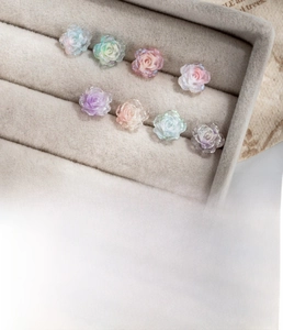 Detailed view of colorful resin camellia earrings on velvet with titanium steel posts