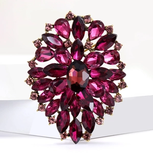 Detailed close-up of retro alloy brooch with marquise-cut rhinestones and glass gems