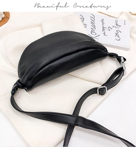 Close-up of a black PU leather crescent waist bag with adjustable strap and metal buckle