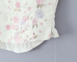 Detail view of floral mesh lace top with invisible side zipper and gathered bottom hem