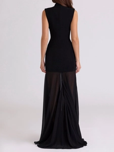 Rear view of sleek black sleeveless dress featuring chic patchwork sheer tulle hem detail