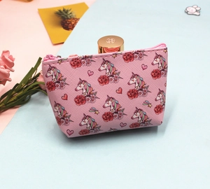 Detailed view of pink unicorn makeup pouch with floral patterns and shell-shaped structure
