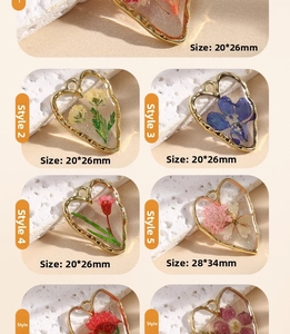 Detail view of heart-shaped resin pendants with colorful dried flowers in gold frames
