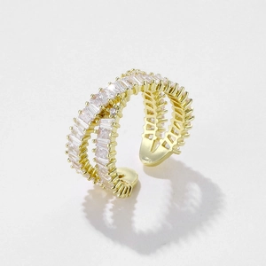 Close-up of triple-layer gold open ring with baguette-cut cubic zirconia crystals