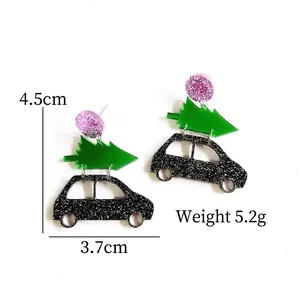 Detail view of 4.5cm Christmas tree acrylic earrings with purple and black glitter accents