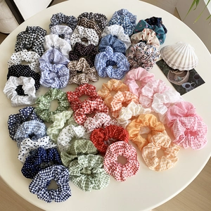 Set of 30 assorted fabric scrunchies with floral, polka dot, and gingham patterns