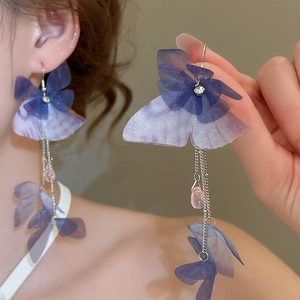 Detail of purple fabric butterfly earrings with crystal tassels and water drop pendants