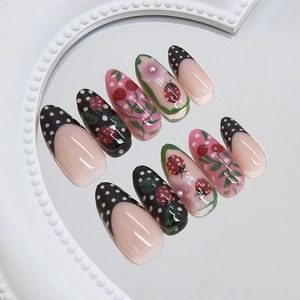 French ladybug and black polka dot press-on nails in almond shape with 3D floral accents