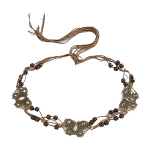 Bohemian braided belt with brown wooden beads and bronze butterfly charms on white background