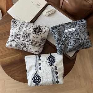 Three-piece linen makeup pouches with paisley and bohemian embroidery patterns