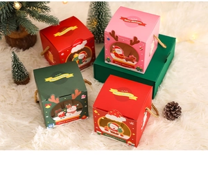 Christmas gift boxes with window design and golden handles on white plush carpet