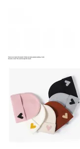 Flat lay of warm knitted beanies in six colors featuring contrast heart embroidery