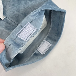Close-up of Morandi blue velvet tissue bag with grey hook and loop fastener detail