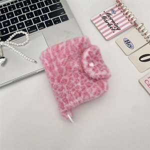 Detail view of a sweet pink leopard print plush coin purse with white button closure.