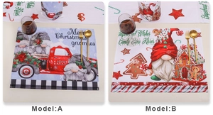 Detail of Christmas placemats with Santa truck and gingerbread house patterns on a table