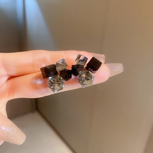 Minimalist geometric square earrings featuring black and smoke gray crystal blocks