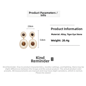 Detail view of oval tiger eye earrings with hollow floral design and size dimensions