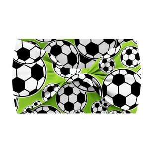 Detail of green 15cm wide elastic headband with black and white football print