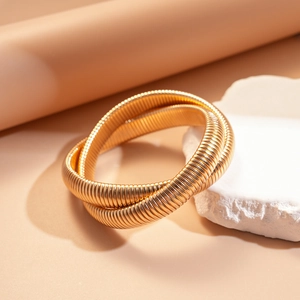 Minimalist gold multi-layer snake bone bracelet with textured metallic twist design