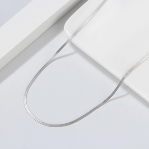 Minimalist S925 sterling silver snake chain necklace displayed on a white ceramic tray