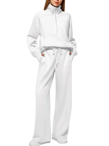 Front view of a white two-piece knit tracksuit featuring a half-zip sweatshirt and wide-leg pants