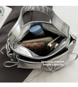 Spacious interior of metallic silver hobo bag showing large main compartment and zipper
