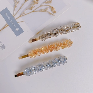 Three crystal beaded hair clips in grey, champagne, and light blue with gold metal base
