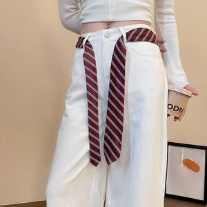 Detail of red white and blue striped silk scarf belt on white high-waisted jeans