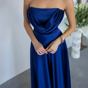 Detail of elegant dark blue satin evening dress showing the pleated strapless neckline