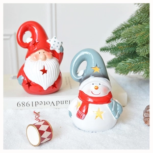 Detail of hollow star pattern on ceramic Santa and Snowman Christmas candle holders