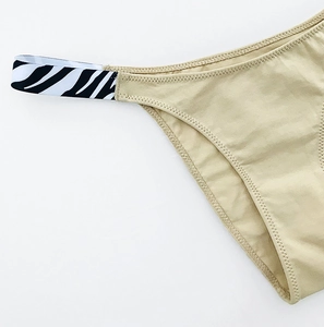 Detail of khaki cotton fabric with zebra pattern elastic waistband and fine stitching
