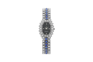 Detail of silver women's watch with blue crystals, quartz movement, and black dial