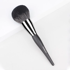 Large powder brush with black gradient bristles and silver ferrule on a white step
